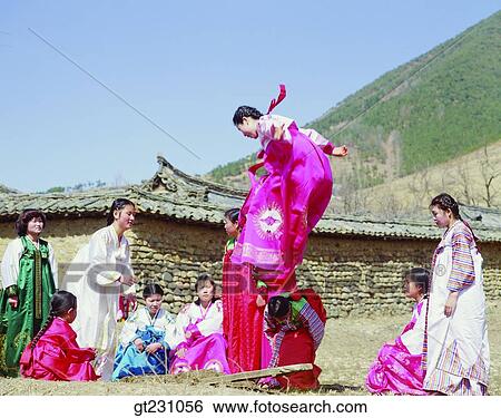 Stock Photograph - seesaw, seesawing, teetertotter, woman, women, female, Korean clothes. Fotosearch