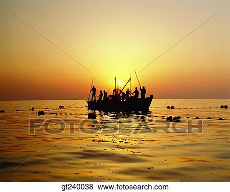 Stock Photo - person, people, many, outdoor, sunrise, sunup, red sky. Fotosearch