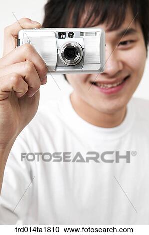 Stock Image - person, oriental, Korean, Asian, young man, camera. Fotosearch