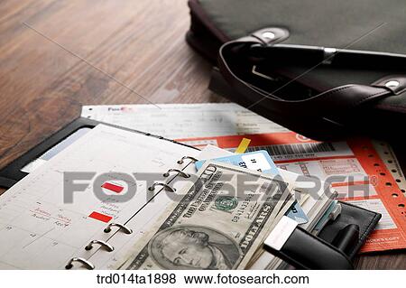 Stock Photo - business, diary, money, paper money, foreign currency, dollar, bag. Fotosearch