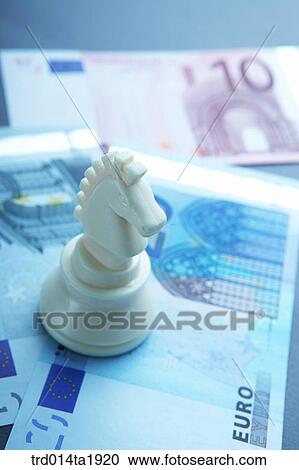 Stock Image - business, money, paper money, chess, horse, Europe currency, Euro. Fotosearch
