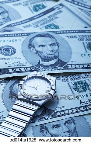 Stock Photo - business, money, paper money, dollar, foreign currency, watch, time. Fotosearch