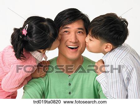 Stock Image - family, daytime, oriental, daughter, kiss, person, indoor. Fotosearch