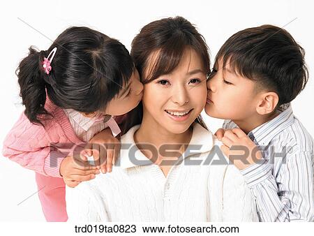 Stock Image - family, daytime, oriental, daughter, kiss, person, indoor. Fotosearch