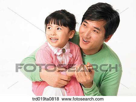 Stock Photo - family, daytime, oriental, daughter, smile, person, indoor. Fotosearch