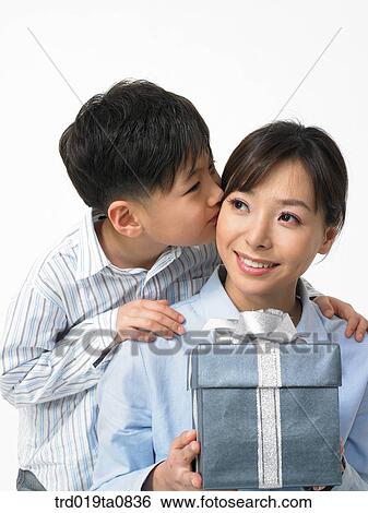 family, daytime, oriental, smile, kiss, person, present View Large Photo Image Stock Photograph - family, daytime, oriental, smile, kiss, person, present. Fotosearch