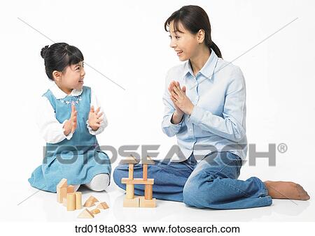 Stock Image - family, education, daytime, play, oriental, daughter, smile. Fotosearch