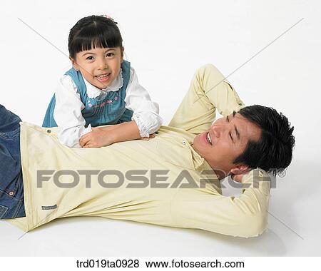 Stock Photo - family, papa, father, person, daughter, indoor, smile. Fotosearch