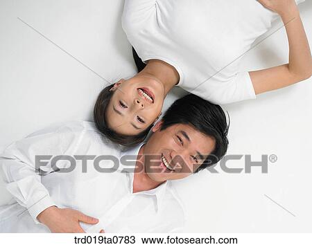 Stock Image - daytime, oriental, couple, person, indoor, sweetheart, laugh. Fotosearch