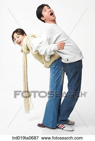 Stock Photo - daytime, oriental, muffler, smile, couple, person. Fotosearch