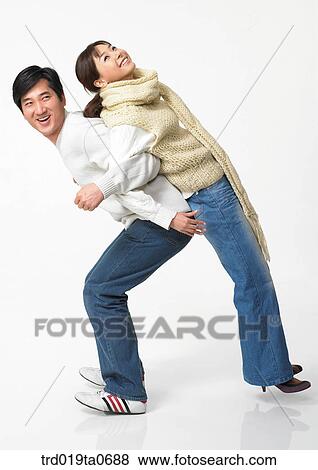 Stock Photo - daytime, oriental, muffler, smile, couple, person. Fotosearch