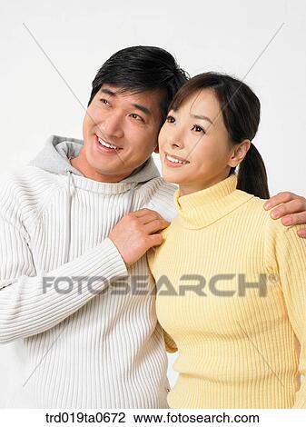 Stock Image - daytime, oriental, smile, couple, person, indoor. Fotosearch