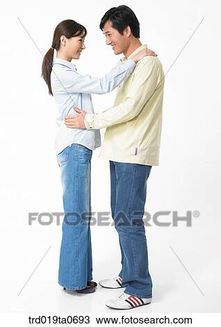 Stock Image - daytime, oriental, smile, couple, person, indoor. Fotosearch