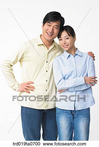 Stock Image - daytime, oriental, smile, couple, person, indoor. Fotosearch
