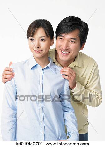 Stock Image - daytime, oriental, smile, couple, person, indoor. Fotosearch