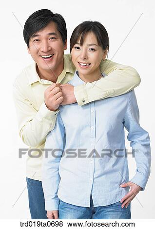 Stock Photo - daytime, oriental, smile, couple, person, indoor. Fotosearch