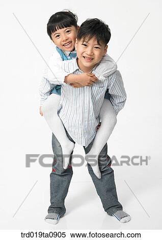Stock Photography - family, brother and sister, daytime, oriental, smile, person, indoor. Fotosearch