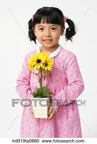 Stock Image - flower, daytime, oriental, smile, person, indoor, child. Fotosearch