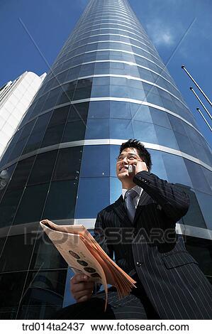 Stock Photo - building, construction, conversation, newspaper, person, oriental, Korean. Fotosearch