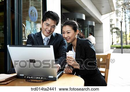Stock Image - cafe, associate, notebook, conversation, person, oriental, Korean. Fotosearch