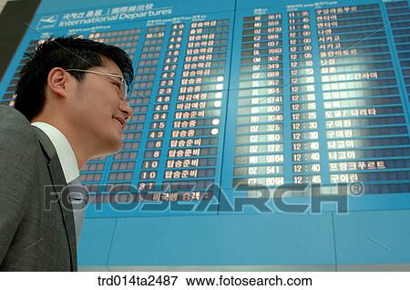 Stock Photo - guidance board, airport, business trip, person, oriental, Korean, Asian. Fotosearch