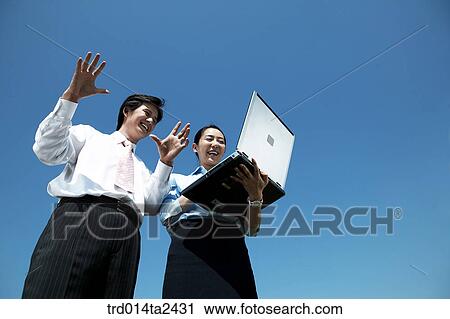 Stock Image - Korean, notebook, oriental, person, conversation, Asian, associate. Fotosearch