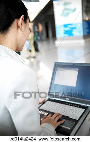 Picture - notebook, trainstation, station, person, oriental, Korean, Asian. Fotosearch
