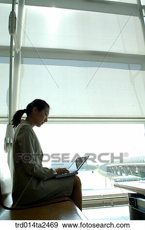 Stock Photo - station, airport, notebook, business trip, person, oriental, Korean. Fotosearch