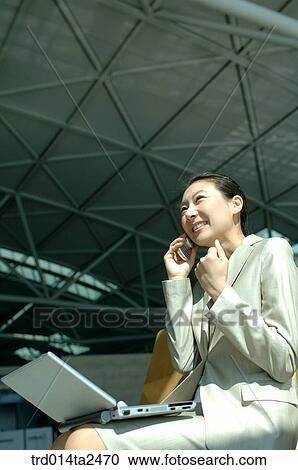 Stock Image - station, airport, notebook, conversation, person, oriental, Korean. Fotosearch