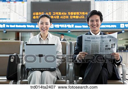 Stock Photo - station, trainstation, notebook, newspaper, person, oriental, Korean. Fotosearch
