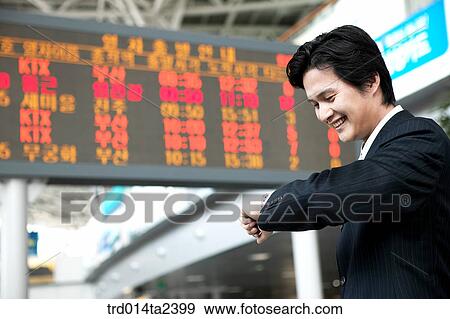 Stock Photo - trainstation, business trip, person, oriental, Korean, Asian. Fotosearch