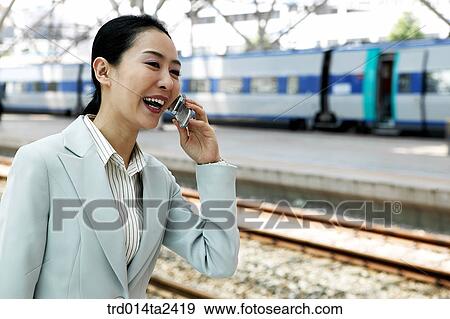 Stock Photo - trainstation, business trip, conversation, person, oriental, Korean, Asian. Fotosearch