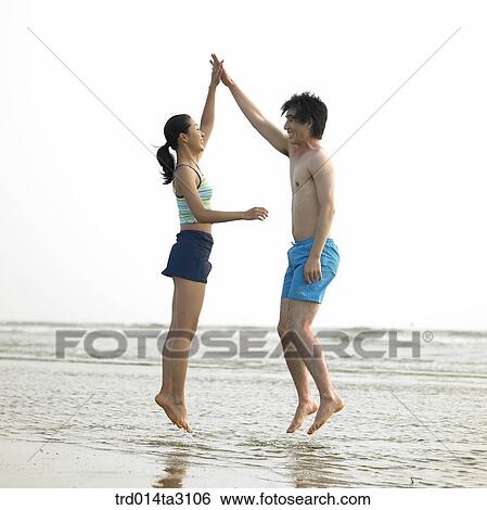 Stock Photograph - gesture, action, posture, high-five, jump, person, Korean. Fotosearch