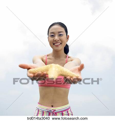 Stock Image - starfish, gesture, posture, person, Korean, summering, vacation. Fotosearch
