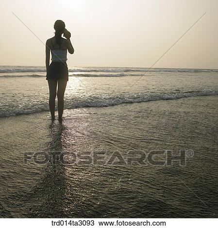 Stock Image - the setting sun, glow, figure from behind, silhouette, person, Korean, summering. Fotosearch