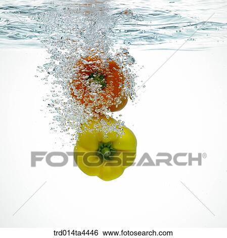 Stock Photograph - Two green peppers in water. Fotosearch
