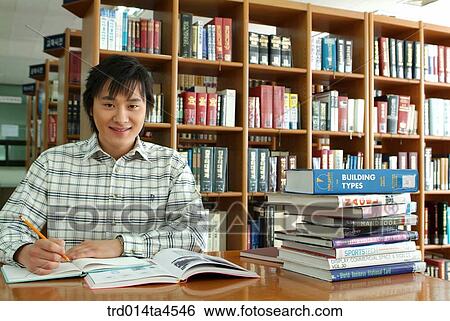 A boy studying in the library View Large Photo Image Stock Photograph - A boy studying in the library. Fotosearch