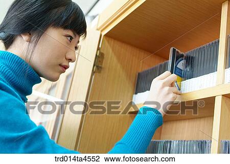 A girl looking for a CD View Large Photo Image Stock Image - A girl looking for a CD. Fotosearch