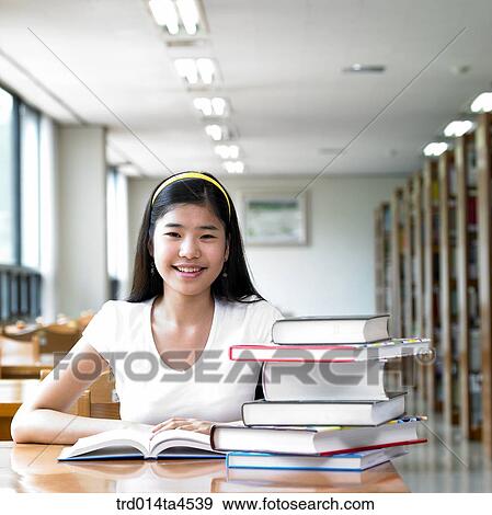 A girl studying in the library View Large Photo Image Stock Photo - A girl studying in the library. Fotosearch