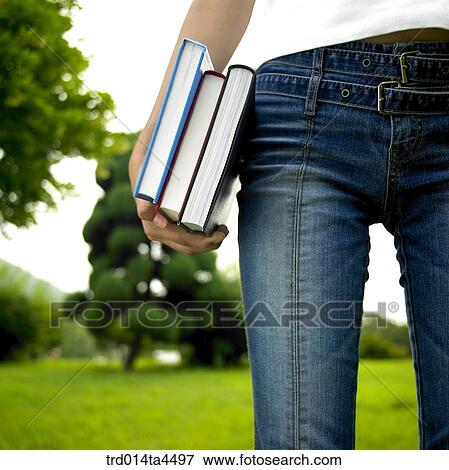 A hand holding books View Large Photo Image Stock Photo - A hand holding books. Fotosearch