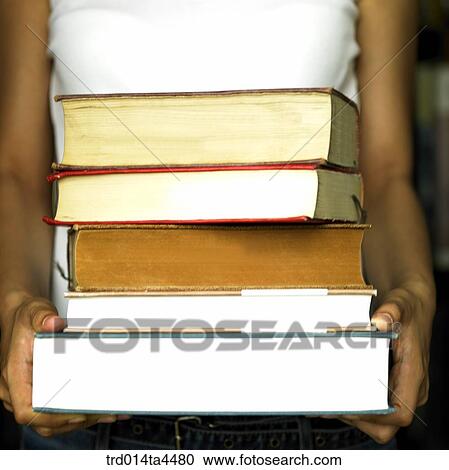 A woman holding many books View Large Photo Image Stock Image - A woman holding many books. Fotosearch