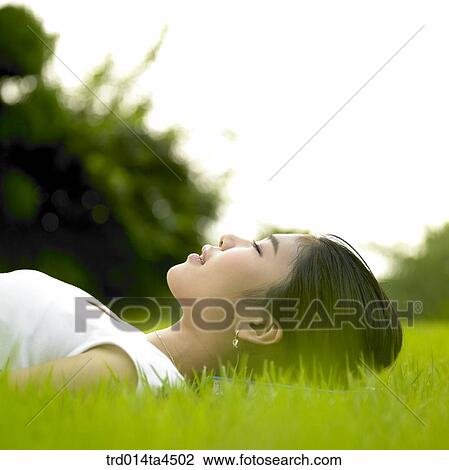 a woman taking a rest on the grass View Large Photo Image Stock Image - a woman taking a rest on the grass. Fotosearch