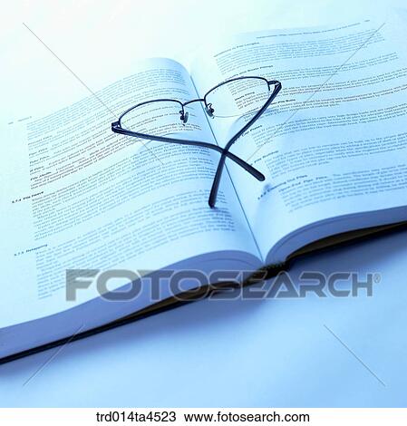 Stock Image - Glasses on the book. Fotosearch