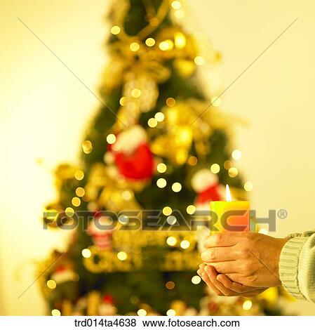 Stock Photo - a hand holding candles. Fotosearch