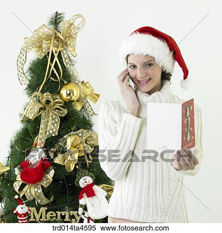 A woman looking at a Christmas card View Large Photo Image Stock Photography - A woman looking at a Christmas card. Fotosearch