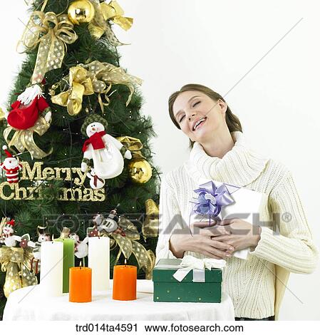 A woman receiving a Christmas gift View Large Photo Image Stock Image - A woman receiving a Christmas gift. Fotosearch
