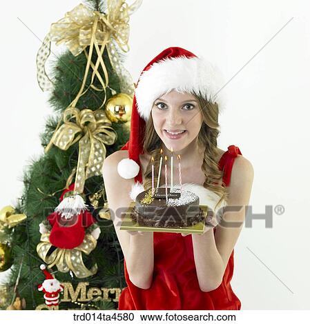 a woman wearing Santa Claus' clothes and holding a cake View Large Photo Image Stock Image - a woman wearing Santa Claus' clothes and holding a cake. Fotosearch
