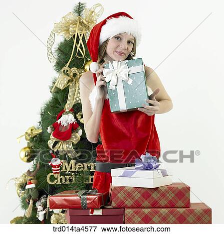 a woman wearing Santa Claus' clothes and giving gifts View Large Photo Image Stock Photo - a woman wearing Santa Claus' clothes and giving gifts. Fotosearch