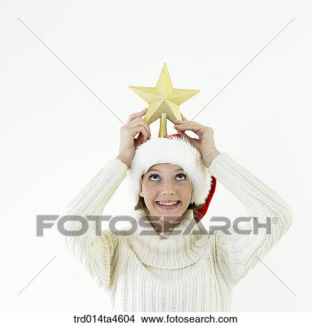 Picture - A woman wearing Santa Claus' hat. Fotosearch