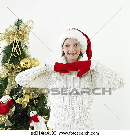 Stock Photo - A woman wearing Santa Claus' hat. Fotosearch